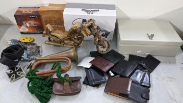 A mixed lot to include a copper John Grey & Sons bugle, wallets, belt, fishing reel, buckles and