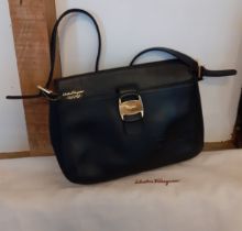 Salvatore Ferragamo- A 'Boutique' black leather shoulder bag with gold tone hardware having an outer
