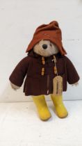 A Paddington Bear with label and yellow boots Location: