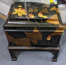 A late 20th century Oriental style chest with black lacquered bird and floral ornament on a stand
