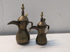 Two Middle Eastern brass, possibly Ottoman Dallah coffee pots, marked to sides, tallest 30cm high