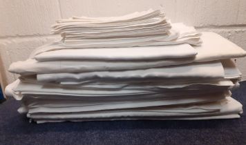 A quantity of mainly mid 20th Century white cotton sheets, tablecloths and napkins to include damask