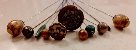 Early 20th Century Oriental hat pins to include Satsuma glazed enamel examples, a pair of white