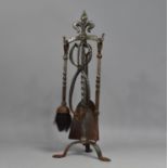A Wrought Iron Fire Companion, Supports with Fleur De Lys Finials, 50.5cms High