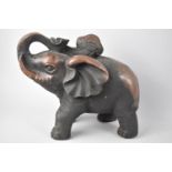 A Patinated Bronze Study of Elephant with Trunk in Salute, 24cms high