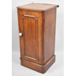 A Late 19th century Mahogany Bedside Cabinet with Ceramic Handle and Moulded Panelled Front,