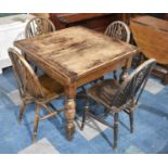 An Oak Draw Leaf Dining Table together with Four Hoop Backed Dining Chairs