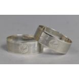 A Pair of Silver Napkin Rings, both with Engine Turned Design and Inscribed 'Mum' & 'Dad',