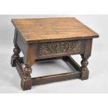 An Early/Mid 20th Century Oak Box Stool, the Rectangular Hinged Top Above Floral Frieze, Turned