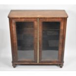 A Victorian Rosewood Veneered Glazed Cabinet Missing Inner Shelves on Turned Supports, 56cms Wide,