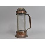 An Arts and Crafts Copper Candle Lamp with Cylindrical Glass Shade and Pierced Lid, 25cms High