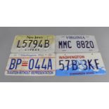A Collection of Reproduction Pressed Metal and Printed American Number Plates