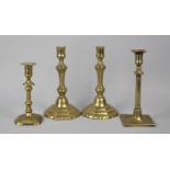 A Pair of Georgian Brass Candlesticks and Two Single Examples, the Tallest 23cm high