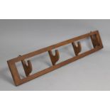 A Wall Hanging Edwardian Coat Rack with Four Hinged Hooks, 70cm Wide