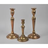 A Pair of Victorian Bronze Candlesticks with Pushers, 27cms High and a Single Example, 17.5cms High
