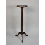 An Edwardian Mahogany Circular Topped Torchere with turned Support, 30cms Diameter and 100cms High