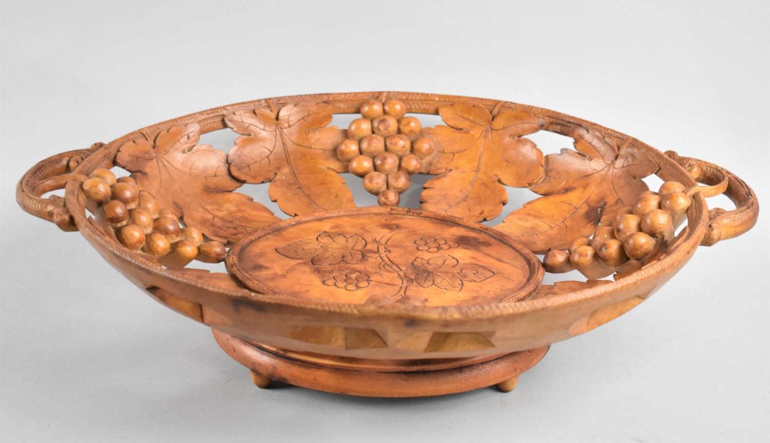 A Mid 20th Century Black Forest Carved Wooden Two Handled Pierced Fruit Basket decorated with Vine