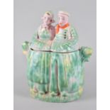 An Arthur Woods Novelty Biscuit Barrel in the Form of a Dutch Couple, 20cms High