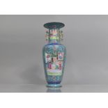 A Chinese Famille Rose Enamel on Copper Vase decorated with Court Scene Cartouches on Blue Ground,