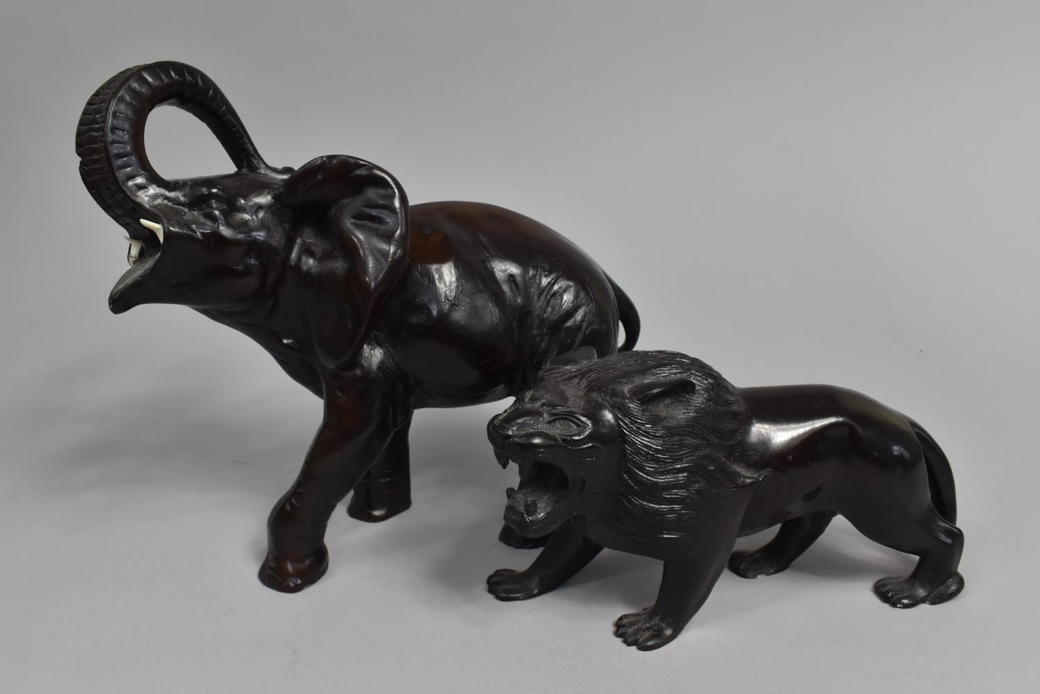 Two Ebonized Resin Figures of African Elephant and Lion