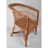 A Vintage Wicker Childs Tub Armchair