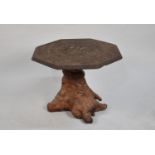 An Intricately Carved Indian Octagonal Table Top Mounted on Tree Trunk Base, 68cms Diameter