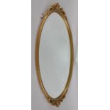 A Gilt Framed Mirror with Bevel Edge, 67x34cms