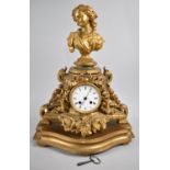 A French Gilt Decorated Spelter Mantel Clock with Maiden Head Finial and Relief Floral Swags