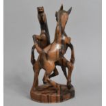 A Carved Hardwood Study of Two Stallions Fighting, 27cms high