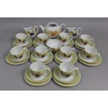 A Royal Worcester Evesham Orchard Tea Set to comprise Ten Cups, Saucers and SIde Plates, Milk Jug,