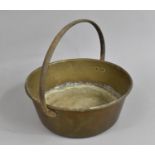 A Vintage Brass Circular Cooking Pot with Iron Loop Handle, 37cms Diameter