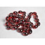 A String of Reproduction Plastic Red Cherry Amber Beads