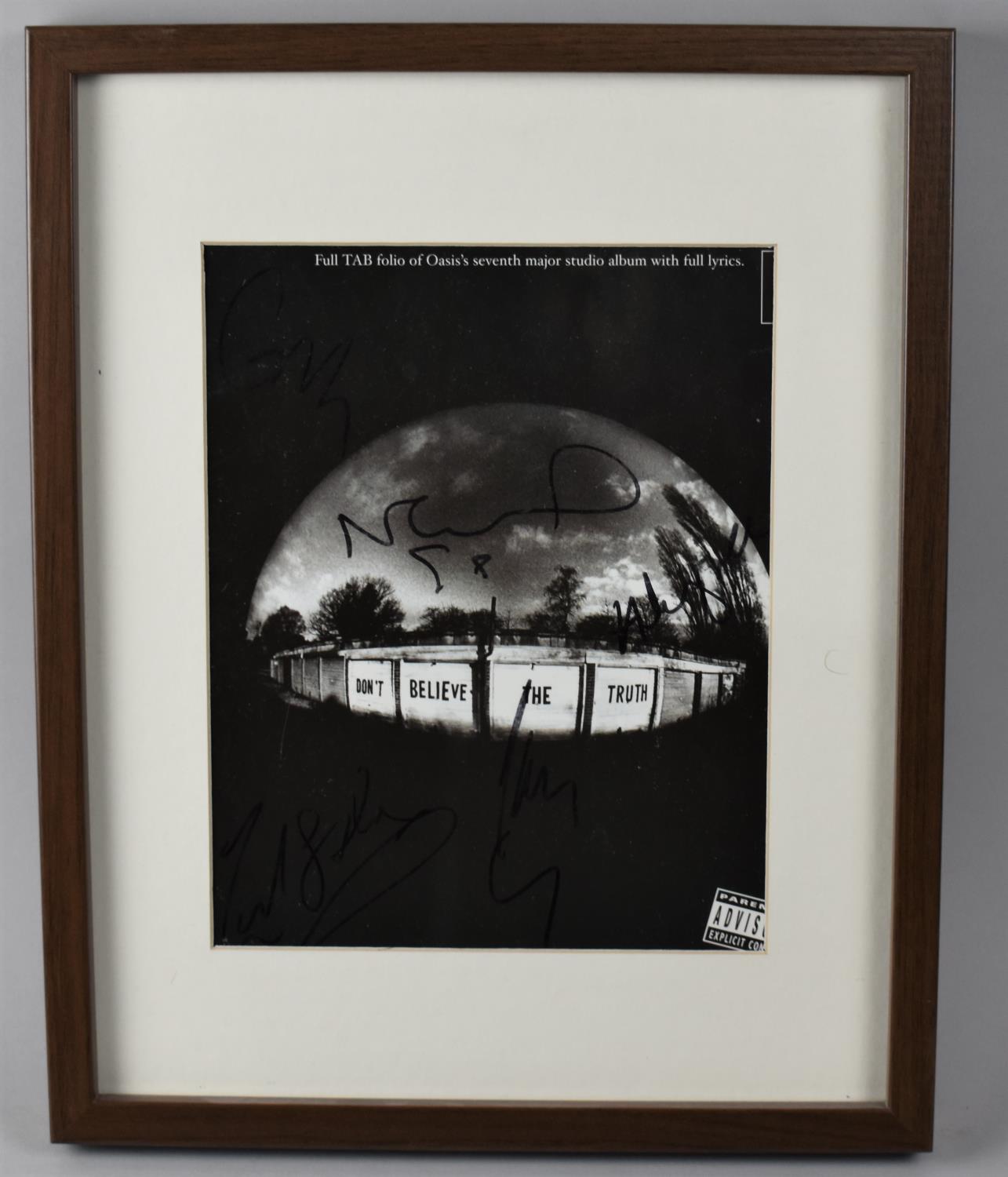 A Framed Signed Oasis Tab Folio Cover With Some Water Damage To Back