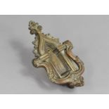 A Brass Door Knocker in the form of a Gothic Arched Doorway 20cms High