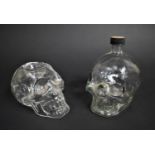 Two Moulded Glass Skulls, Bottle and Tea Light Holder, tallest 15.5cms High