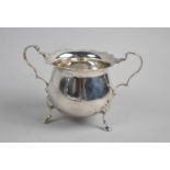 An Edwardian Silver Two handled Sugar Bowl on Three Scrolled Feet, Birmingham 1907, 9cm high