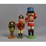 A Collection of Three Painted Continental Wooden Figures, Two Soldier Nutcrackers and Musical