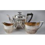 An Edwardian Walker and Hall Three Piece Silver Plated Tea Service