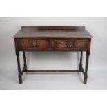 An Edwardian Oak Two Drawer Side Table with turned Supports and Galleried Back, 114cms Wide