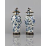 A Pair of Chinese Blue and white Crackle Glazed Baluster Vases and Covers Decorated in Flower.