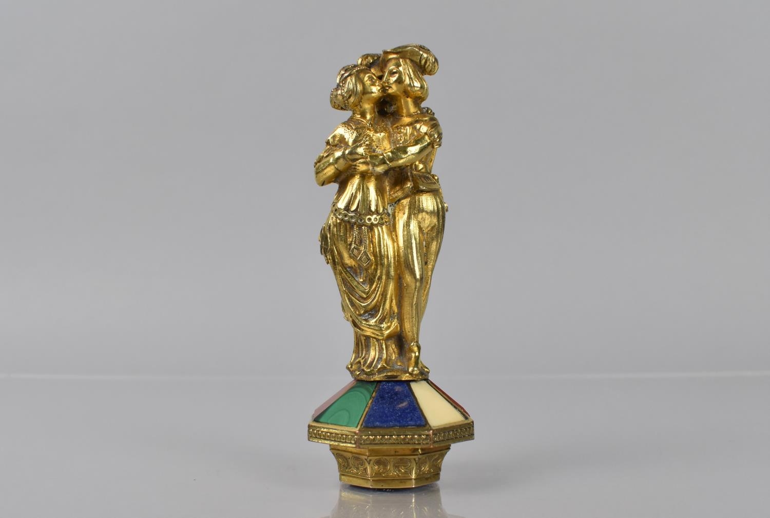 A 19th Century Gilt Metal Seal formed as Three Romantic Figures in an Embrace on Octagonal Base