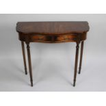 A Reprodux Mahogany Serpentine Front Side Table with Two Small Drawers on Turned Reeded Supports,