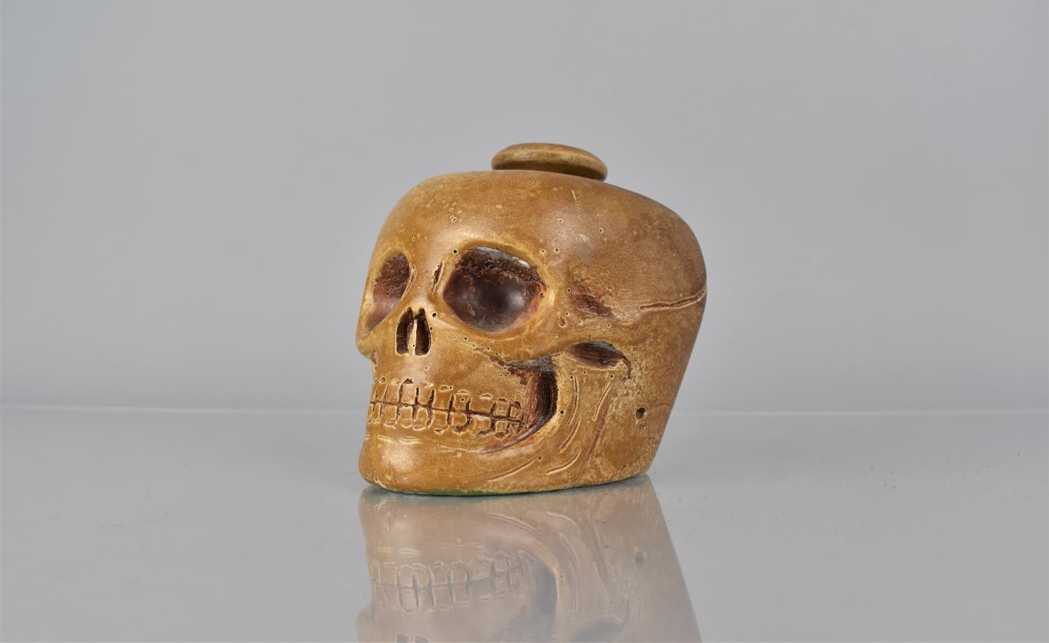 A Late 19th/Early 20th Century Painted Plaster and Wood Tobacco Jar Modelled as a Human Skull,