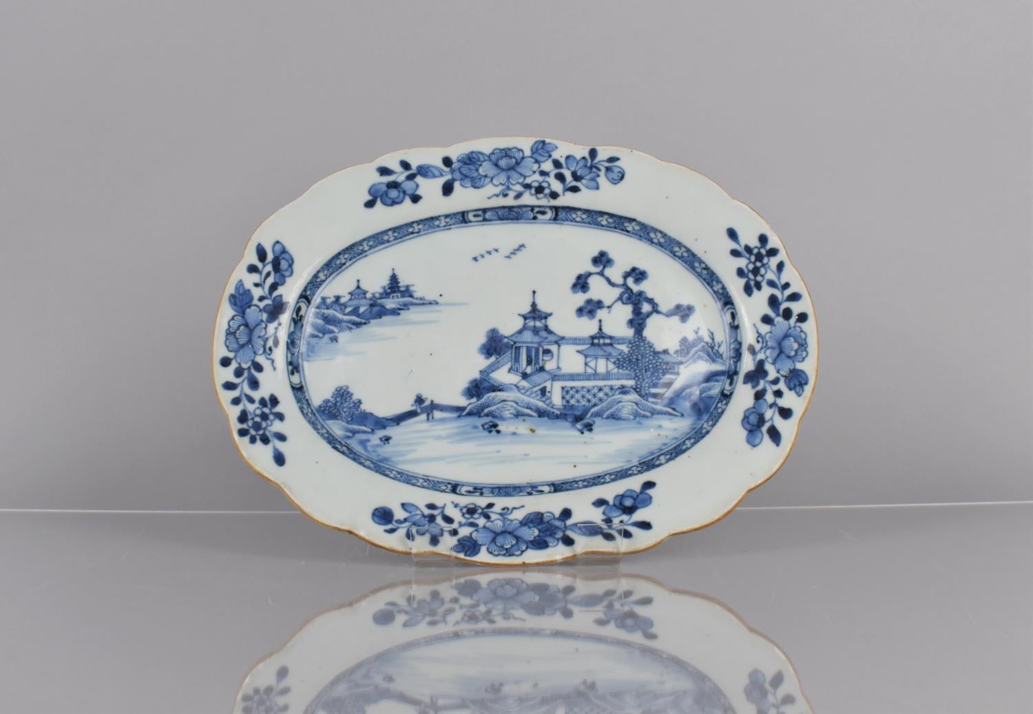 A 19th Century Chinese Blue and White Charger Decorated with River Village Scene and Floral