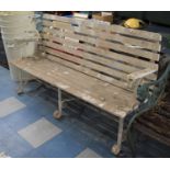 A Wooden Slatted and Cast Iron Framed Garden Bench, 151cms Wide