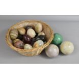 A Collection of Polished Stone Balls and Eggs in Wicker Basket