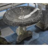 A Reconstituted Bird Bath of Moulded Dolphin Tripod Support, 64cms Diameter, Repair to Bowl