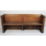 A Late Victorian Oak Pew with Gothic Carved End Panel and Rear Prayer Book Shelf, 181cms Long