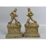 A Pair of Victorian Cast Brass Door Stops Depicting Sportsmen with Rugby Ball and Football