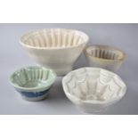 A Collection of Three Vintage and One Reproduction Jelly Moulds